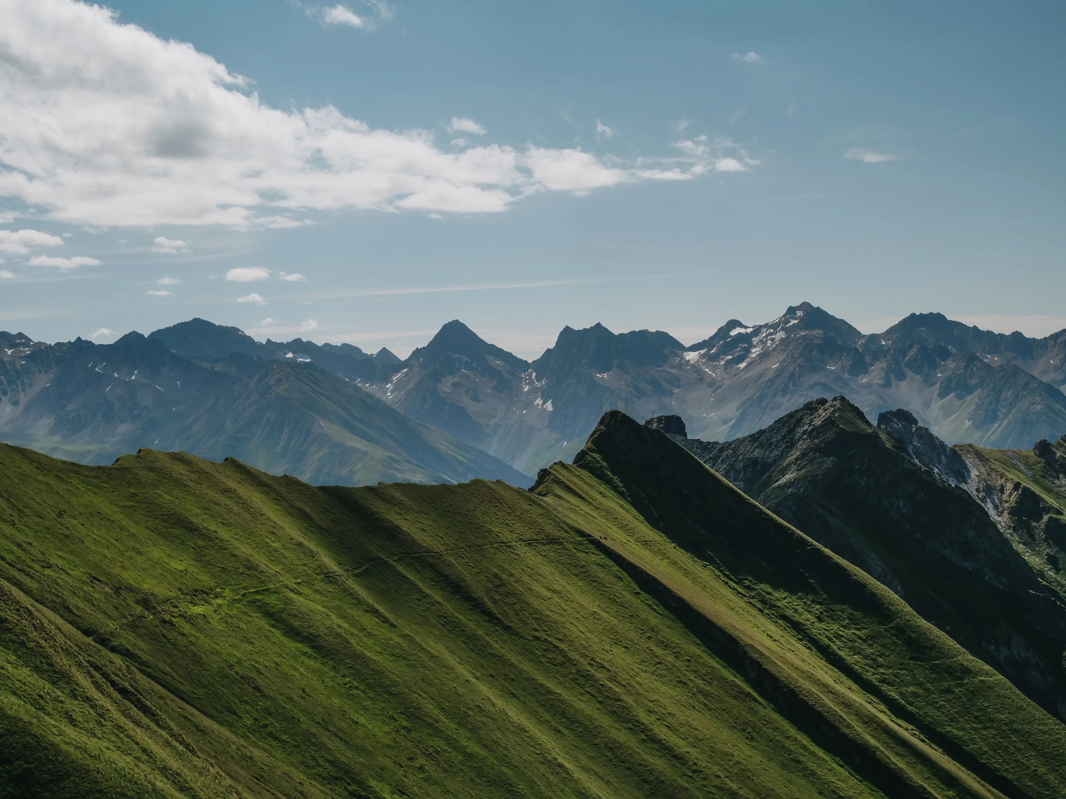 Green mountain peak with a clear blue sky